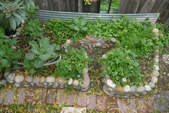 Permasystems designed and built raised keyhole garden bed using local natural materials