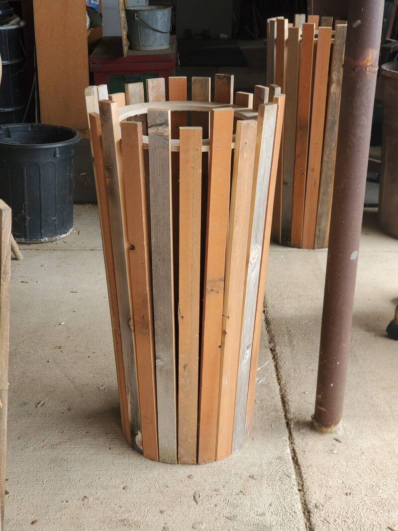 Vertical slat bin built using reclaimed wood to collect plastic for reuse in art projects