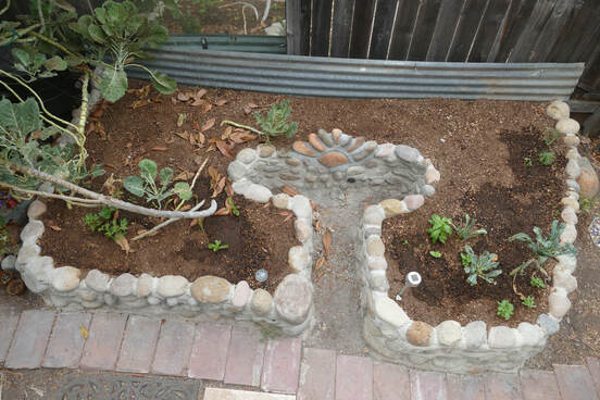 Permasystems designed and built raised keyhole garden bed using local natural materials
